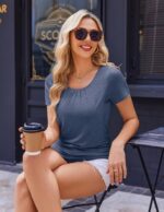 Woman sitting in slate blue short sleeve nursing top with coffee