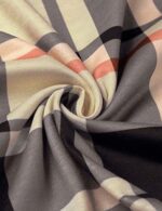 Close-up of soft beige plaid tunic fabric