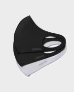 Stack of black and grey stretch face masks with fabric ear loops