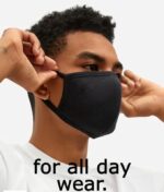 Man adjusting the ear loops of a black cotton mask
