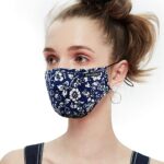Navy cotton mask with white floral pattern shown on a model