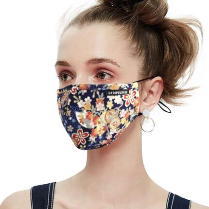 Navy and orange flower print cotton mask worn by a woman, side view