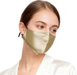 Gold satin-sheen silk face mask worn by a model