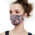 Woman wearing a UTRIPSUNEW floral cotton face mask for women in a purple flower print