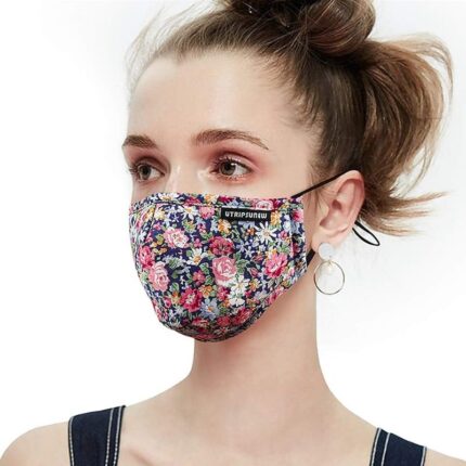 Woman wearing a UTRIPSUNEW floral cotton face mask for women in a purple flower print